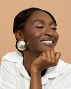 Yaayaa stud earrings made from hand-faceted wood and silver foil, handmade in Ghana