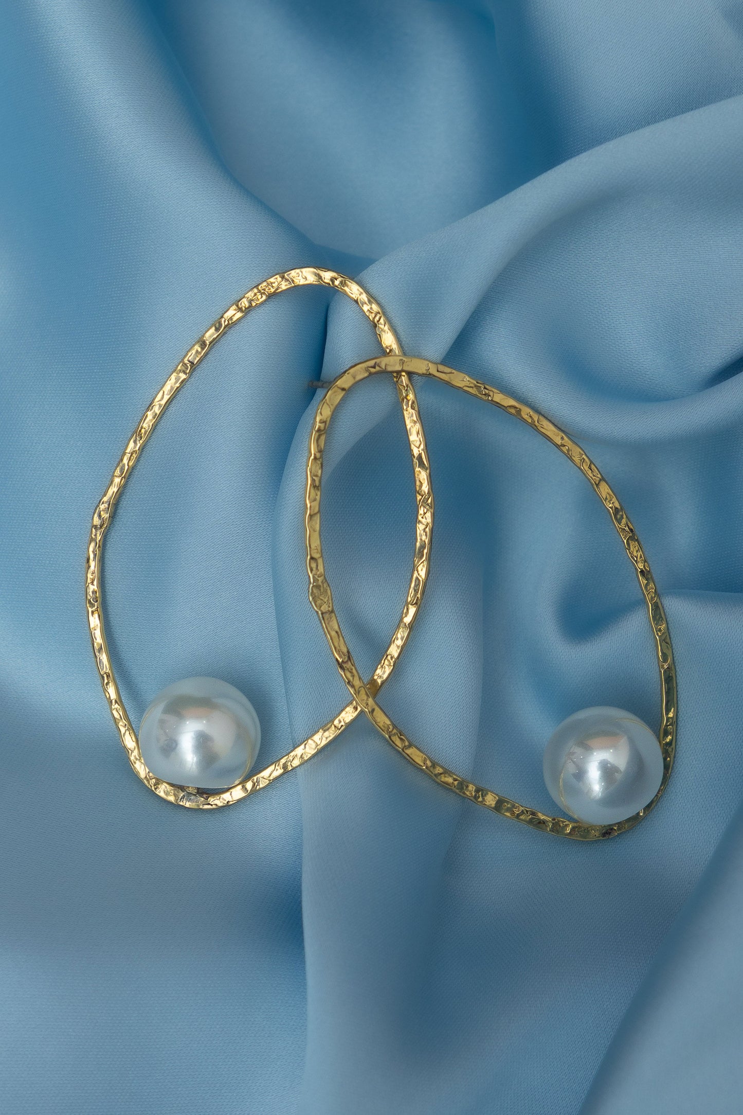 Lamiorkor stud earrings made from textured brass with white pearl detail