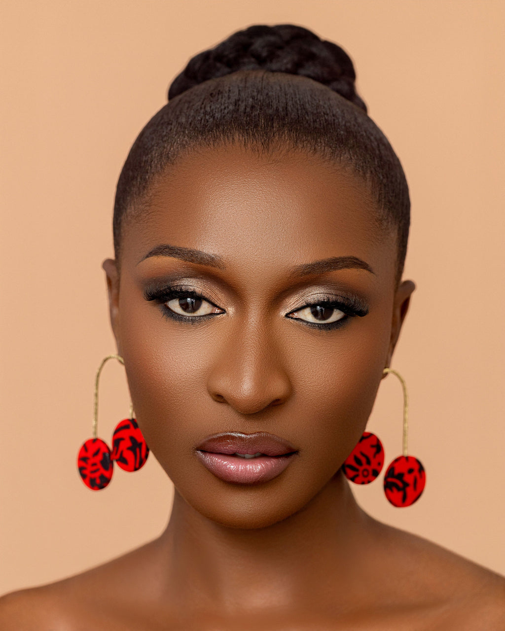 Takyiwaa red earrings handmade from textured brass and African print fabric